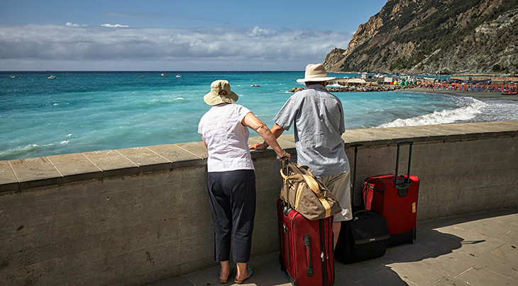 seniors, senior couple, older adults, 50 plus couple, vacation, traveling, suitcases, luggage, trip, beach