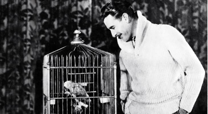 american actor, john gilbert, jack gilbert, silent films, movie star, pet bird, parrot, fashion, menswear, sweater, 1929, 1920s